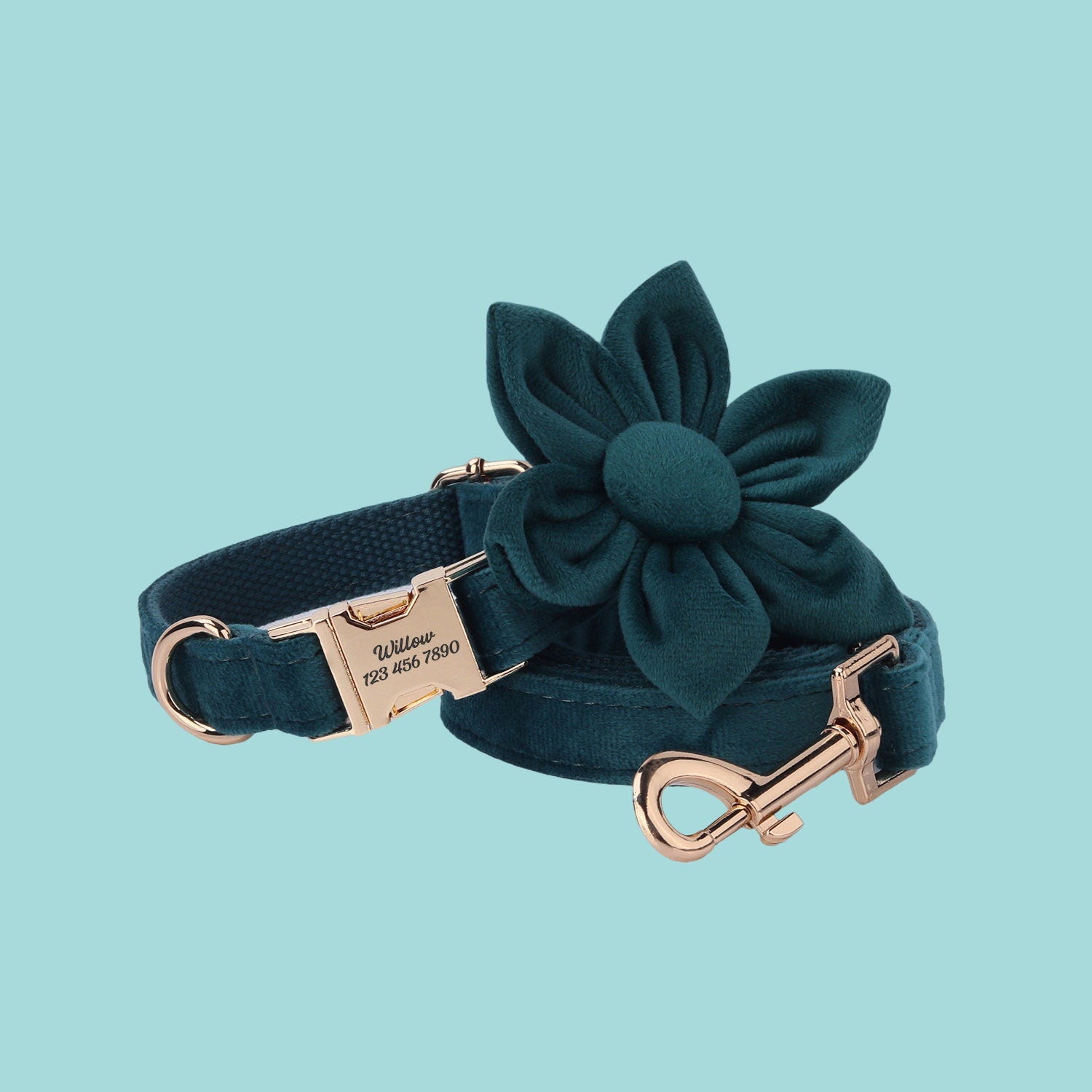 a green dog collar with a flower on it